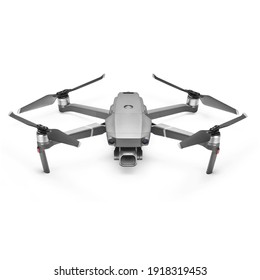 Aerial Drone Isolated on White Background. Front View of Quad Copter with Digital Camera. Flying Remote Control Air Drone. Headless Quadcopter with 4K Hasselblad Camera and Remote Control
