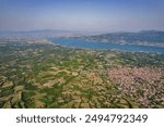 Aerial drone morning view over Polyfytos artificial lake and Velventos village. Larissa, Greece.