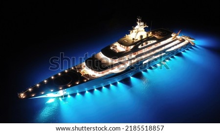 Aerial drone night shot with copy space of beautiful latest technology modern led illuminated luxury mega yacht anchored in tropical exotic bay with deep blue sea