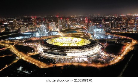 Aerial drone night shot of iconic illuminated London Stadium in Queen Elisabeth park at Christmas, London, United Kingdom