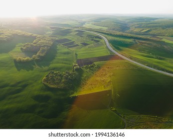 Aerial Drone Overhead Of Cars Driving Down Straight Road Through Leafless Forest Valley At Sunset. Highway Go Through European Ecosystem Wildlife Habitat Natural Environment Concept Scandinavia 4K.