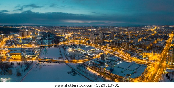 Aerial drone panorama; beautiful view\
Chelyabinsk city with illuminated streets and bridges at night;\
winter evening South Ural capital; industrial and pollution\
problem; undeveloped urban\
environment