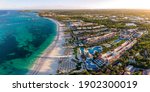 Aerial drone panorama view of beach resort hotels with pools, umbrellas and blue water of Atlantic Ocean, Bavaro, Punta Cana, Dominican Republic