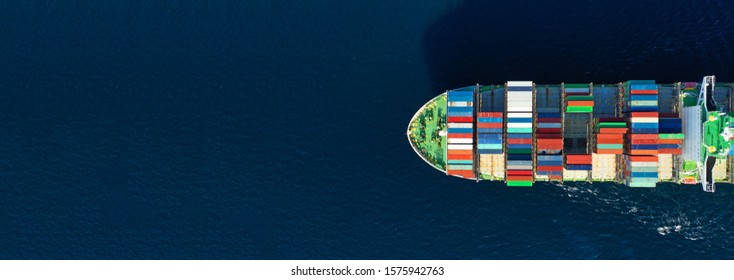 Aerial drone panoramic photo of industrial container tanker cruising in open ocean deep blue sea
