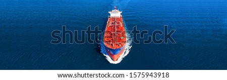 Aerial drone panoramic photo of industrial crude oil and fuel tanker ship cruising deep blue open ocean sea