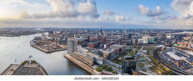 Aerial Drone Panoramic View Of Port Of Hamburg From Above Before Sunset With Dramatic Stormy Clouds Over The Sea Port