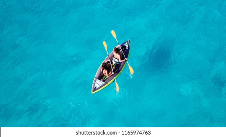 Aerial drone photo of 2 women canoeing in tropical Caribbean exotic destination with turquoise sea - Powered by Shutterstock