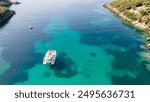 Aerial drone photo of beautiful catamaran sailing yacht anchored in tropical exotic turquoise sea exotic bay. Drone view - birds eye angle. Yachting and travel concept. Beautiful sailing catamaran 