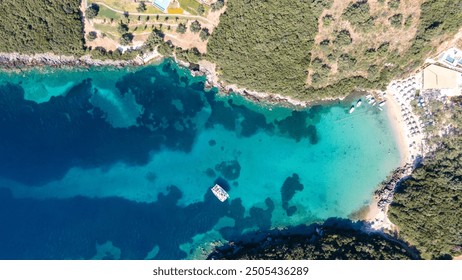 Aerial drone photo of beautiful catamaran sailing yacht anchored in tropical exotic turquoise sea exotic bay. Drone view - birds eye angle. Yachting and travel concept. Beautiful sailing catamaran  - Powered by Shutterstock