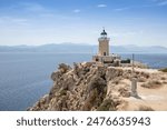 Aerial drone photo of beautiful and picturesque cape Melagavi forming a small peninsula with unique lighthouse stand out next to archaeological site of Heraion, Loutraki, Greece