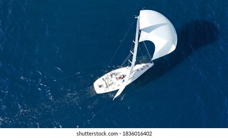 Aerial drone photo of beautiful sailboat with white sails cruising deep blue sea in low speed near Mediterranean destination port - Shutterstock ID 1836016402
