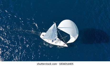 Aerial drone photo of beautiful sailboat with white sails cruising deep blue sea in low speed near Mediterranean destination port - Shutterstock ID 1836016405