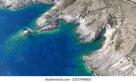 Aerial drone photo of beautiful turquoise beach and cave formations visited by yachts and sailboats in Southern part of Antiparos island, Cyclades, Greece - Shutterstock ID 2321998803