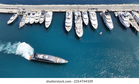 Aerial drone photo of beautiful yacht manoeuvring inside round port of Zea or Passalimani a safe anchorage in seaside area of Piraeus, Attica, Greece