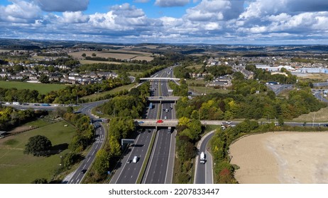 Aerial Drone Photo Of The Busy M1 Motorway With Three Bridges Crossing Over The Highway In The Village Of Barnsley In Sheffield UK In The Summer Time On A Bright Sunny Summers Day.