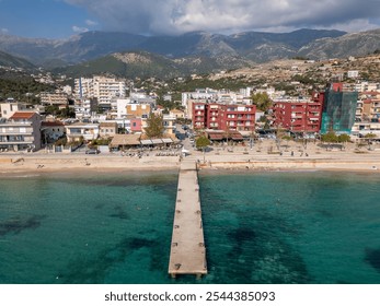 Aerial drone photo of the coastal town of Himare in Albania. Himare is a popular holiday destination and the town has a beautiful bay and beach.