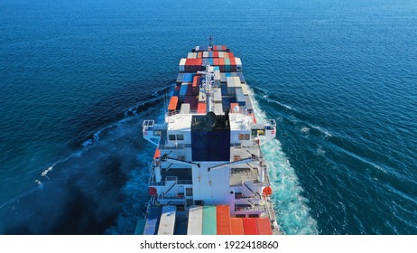 Aerial Drone Photo Of Colourful Truck Size Container Tanker Ship Cruising Deep Blue Sea Near Commercial Port Of Piraeus, Attica, Greece