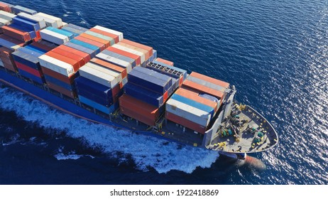 Aerial Drone Photo Of Colourful Truck Size Container Tanker Ship Cruising Deep Blue Sea Near Commercial Port Of Piraeus, Attica, Greece