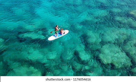 Aerial Drone Photo Of Couple Practicing Stand Up Paddle Or SUP In Tropical Exotic Emerald And Sapphire Island Sea