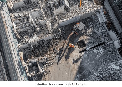 Aerial drone photo of demolition site and construction workers using heavy machinery - Powered by Shutterstock