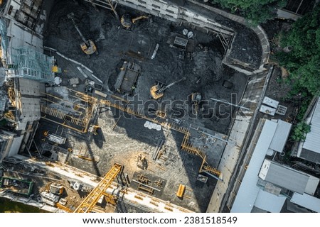 Aerial drone photo of demolition site and construction workers using heavy machinery