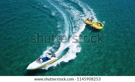Aerial drone photo of extreme powerboat donut water-sports cruising in high speed in tropical turquoise bay