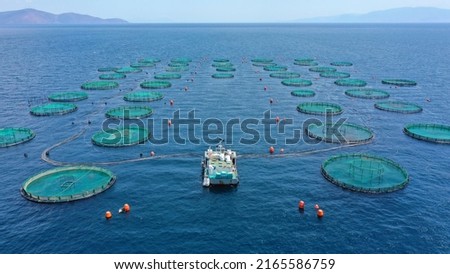 Aerial drone photo of fish farming industry net round fish hatching cages in Mediterranean deep blue seep sea waters