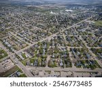 An aerial drone photo of the Forest Grove neighborhood in Saskatoon, Saskatchewan, featuring residential homes, tree-lined streets, parks, and green spaces in this family-friendly community.