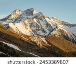 Aerial drone photo. French alps in winter,  Rhone Alpes in France Europe . Les deux alpes village in spring time. Town in the alps mountains during sunset. Winter French Alpes town  from drone.