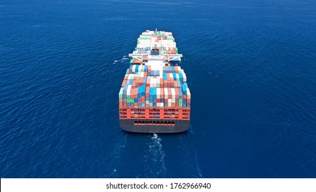 Aerial Drone Photo Of Fully Loaded Truck Size Container Ship Cruising In Open Ocean Deep Blue Sea