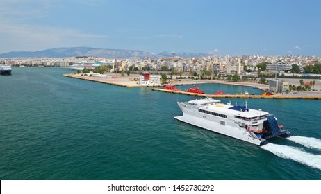 Aerial Drone Photo Of High Speed Passenger Catamaran Ferry Approaching In Low Speed Iconic Port Of Piraeus, Attica, Greece