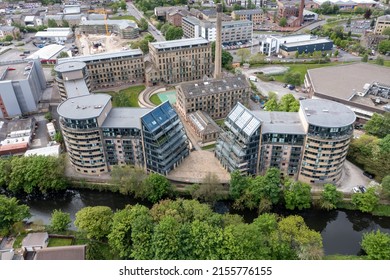 Aerial drone photo of the historic town of Shipley in the City of Bradford, West Yorkshire, England showing a Newley regenerated development of apartment buildings by the by the River Aire