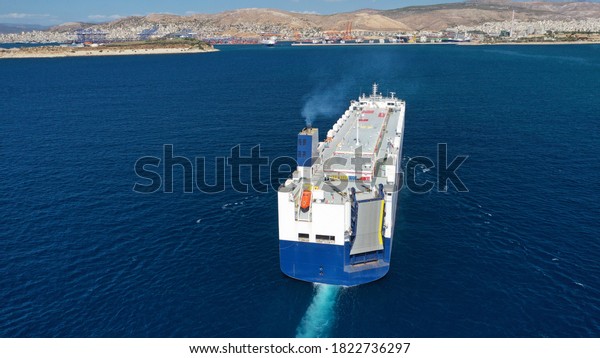Aerial\
drone photo of huge car carrier ship RO-RO (Roll on Roll off)\
cruising in Mediterranean deep blue Aegean\
sea