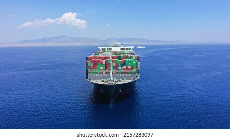 Aerial Drone Photo Of Huge Container Tanker Ship Bow Carrying Truck Size Colourful Containers In Deep Blue Open Ocean Sea