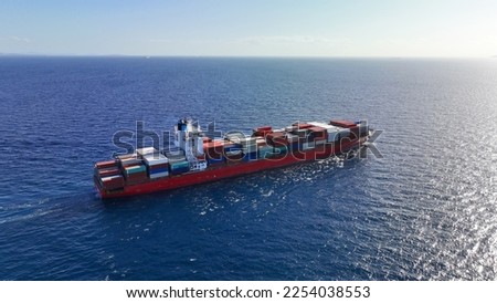Aerial drone photo of huge fully loaded container truck size tanker ship cruising deep blue sea
