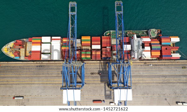Aerial drone photo of industrial cargo area with\
cranes, container ships and logistics, Piraeus port, Drapetsona,\
Perama, Attica, Greece