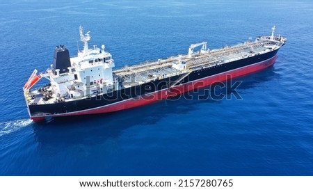 Aerial drone photo of industrial crude oil - fuel tanker ship cruising deep blue Mediterranean sea
