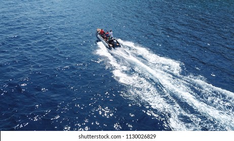 Aerial drone photo of inflatable rib rescue boat cruising in high speed in deep blue mediterranean sea