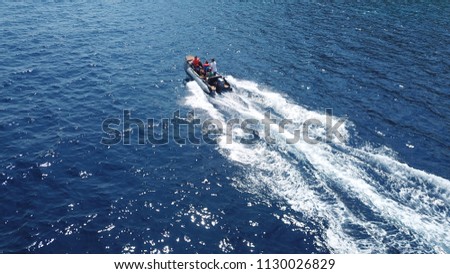 Aerial drone photo of inflatable rib rescue boat cruising in high speed in deep blue mediterranean sea