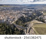 Aerial drone photo of the Italian town named Gravina in Puglia. The town has an old roman bridge in a gorge.