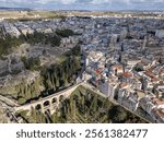 Aerial drone photo of the Italian town named Gravina in Puglia. The town has an old roman bridge in a gorge.