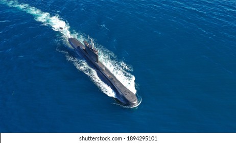 Aerial drone photo of latest technology navy armed diesel powered submarine cruising half submerged deep blue sea
