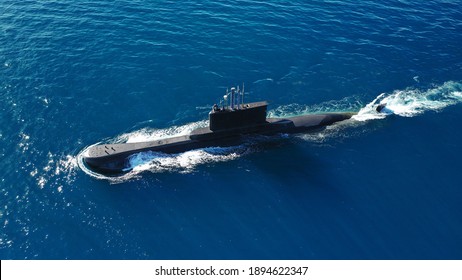 Aerial drone photo of latest technology naval armed forces submarine cruising in deep blue open ocean sea