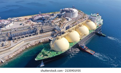Aerial drone photo of LNG (Liquified Natural Gas) tanker anchored in small gas terminal island with tanks for storage - Shutterstock ID 2135901935