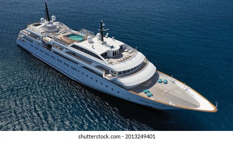 Aerial Drone Photo Of Luxury Mega Yacht With Wooden Deck And Pool Facilities Anchored In Mediterranean Open Ocean Deep Blue Bay