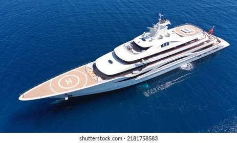 Aerial Drone Photo Of Luxury Mega Yacht With Wooden Deck And Helipad Anchored In Deep Blue Aegean Sea