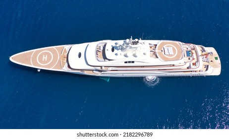 Aerial Drone Photo Of Luxury Mega Yacht With Wooden Deck And Helipad Anchored In Deep Blue Aegean Sea