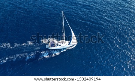 Aerial drone photo of luxury sail boat cruising in the deep blue Aegean sea, Greece