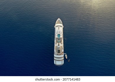Aerial drone photo of mega yacht in aegean sean in mykonos greece