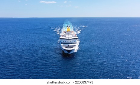 Aerial drone photo of passenger ferry reaching destination - busy port of Piraeus, Attica, Greece